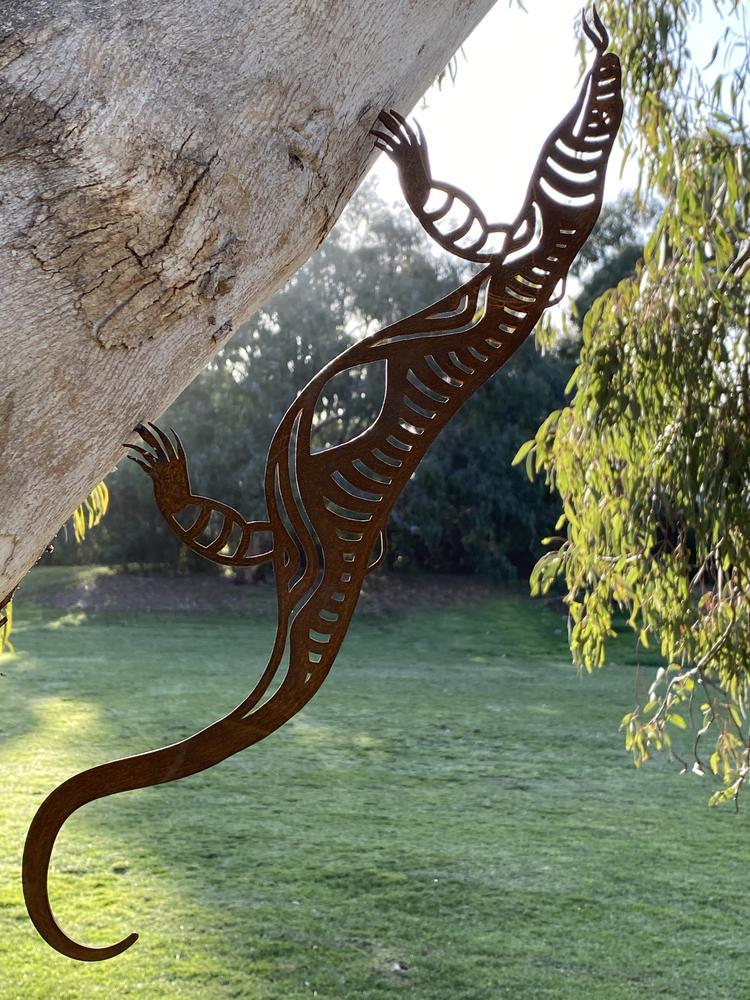 Dhulin the Goanna is one of the 6 special men who helped Bundjil the Wedge Tailed Eagle when he created the Earth. Bundjil taught all the special men how to look after his creations - the mountains & the rivers, man, woman & all the animals. He taught them how to make weapons, how to fight with them, & how to behave with one another. Bellum Bellum the Musk Crow blew Dhulin &  the other special men to the stars. Ngarga Warendj x Animalia - Metal Art Australian Made animals for your garden