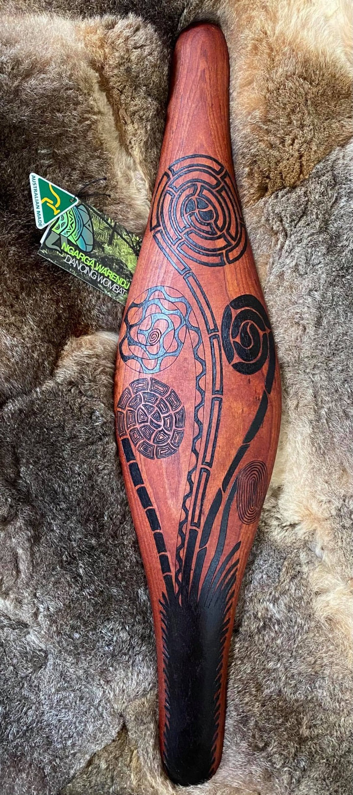 Traditionally malgarr ( shields ) were used with liyangayil ( fighting clubs) for hand to hand combat with our enemies. I have replicated the shape ofthese shields in my artwork. The Kwambee djak or common tree fern was used as a staple food by our old people during the Warendj (wombat season) or cooler months. Handcrafted in Australia from Australian Red Cedar by Mick Harding Ngarga Warendj Dancing Wombat