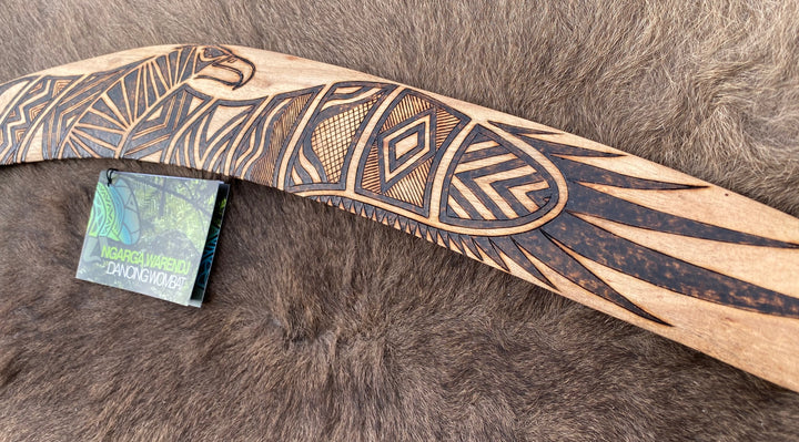 Large Bundjil the Wedge Tailed Eagle Wangim / Boomerang. Made from Stringybark timber.  Hand Crafted in Australia.  All artefacts come with an information card.  The card has information about the artist, artefact and design. All our wangim are made from timber collected from tree roots or branches that have a natural bend. All designs are based on traditional symbols from South East Australia