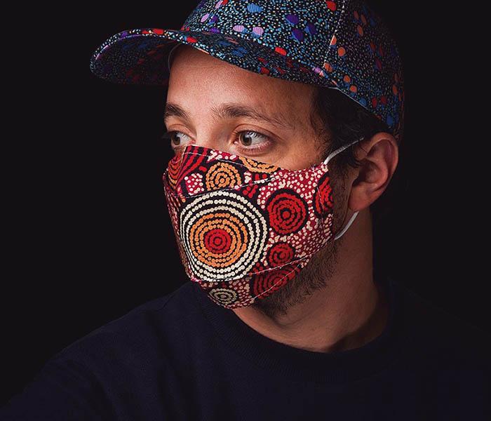 Alperstein Designs range of Australian made 100% cotton face masks featuring beautiful Aboriginal Artwork by Warlukurlangu Artists & Munupi Arts.  There’s a filter pocket on the inside of the mask. using the  adjustable nose wire, you can adjust the mask for a close fit to  your face. Elastic loops fit around your ears to hold the mask in  place.  One size fits most. These masks do not claim to give you respiratory protection from viruses but may help prevent the spread of germs to others.