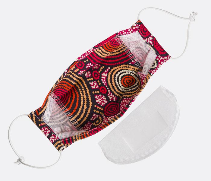 Alperstein Designs range of Australian made 100% cotton face masks featuring beautiful Aboriginal Artwork by Warlukurlangu Artists & Munupi Arts.  There’s a filter pocket on the inside of the mask. using the  adjustable nose wire, you can adjust the mask for a close fit to  your face. Elastic loops fit around your ears to hold the mask in  place.  One size fits most. These masks do not claim to give you respiratory protection from viruses but may help prevent the spread of germs to others.