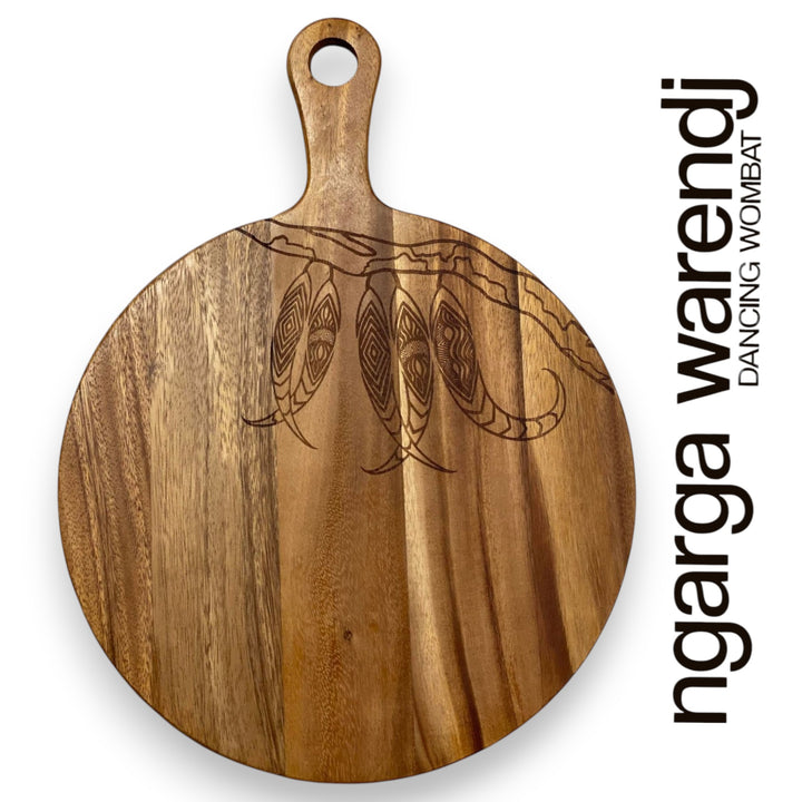 Wooden cutting board with turtle design and 'ngarga warendj' branding on a white background