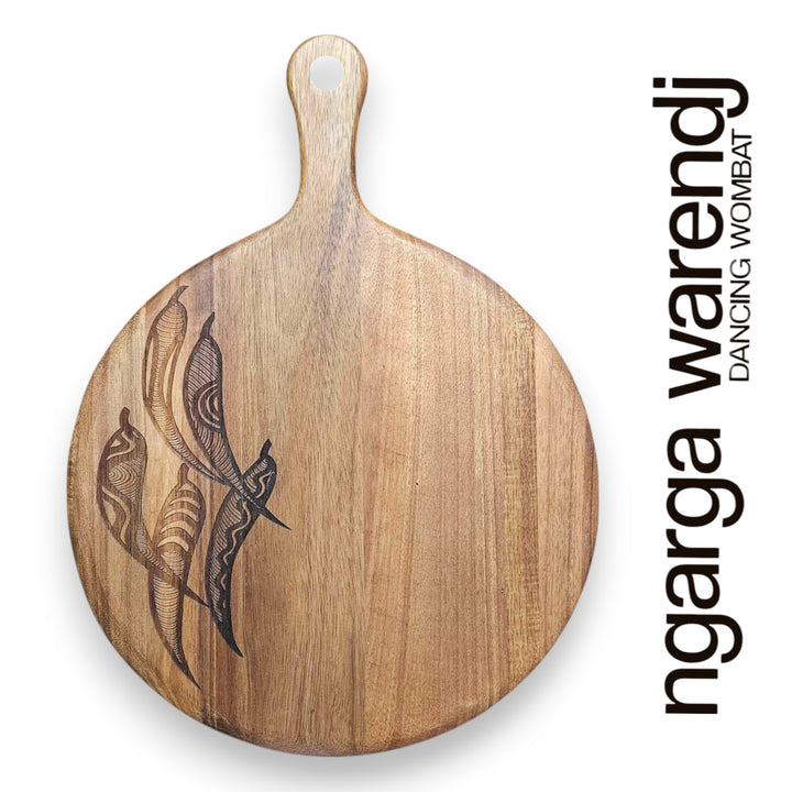 Wooden cutting board with engraved design on a white background, featuring the brand 'ngarga warendj'.