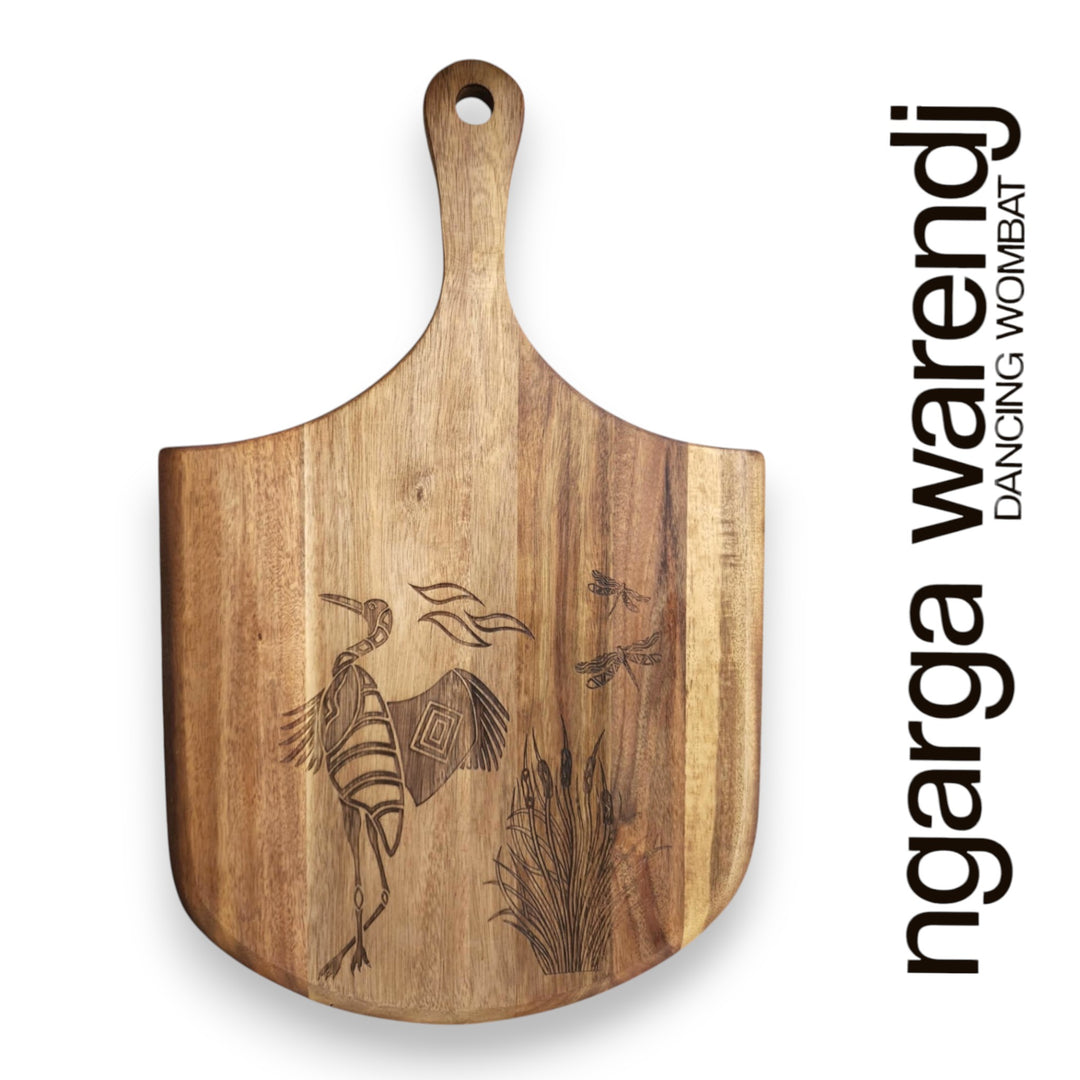 Wooden cutting board with engraved design on a white background, featuring the brand 'ngarga warendj'.