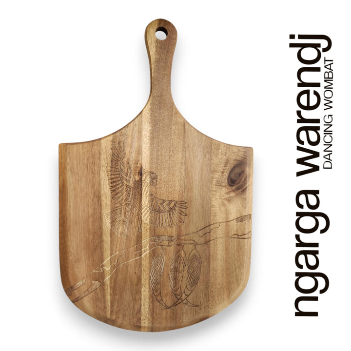 Wooden cutting board with engraved design on a white background, featuring the brand 'ngarga warendj'.