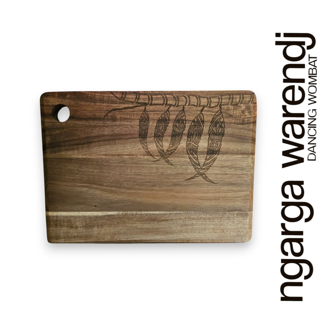 Wooden cutting board with engraved design on a white background, featuring the brand 'ngarga warendj'.