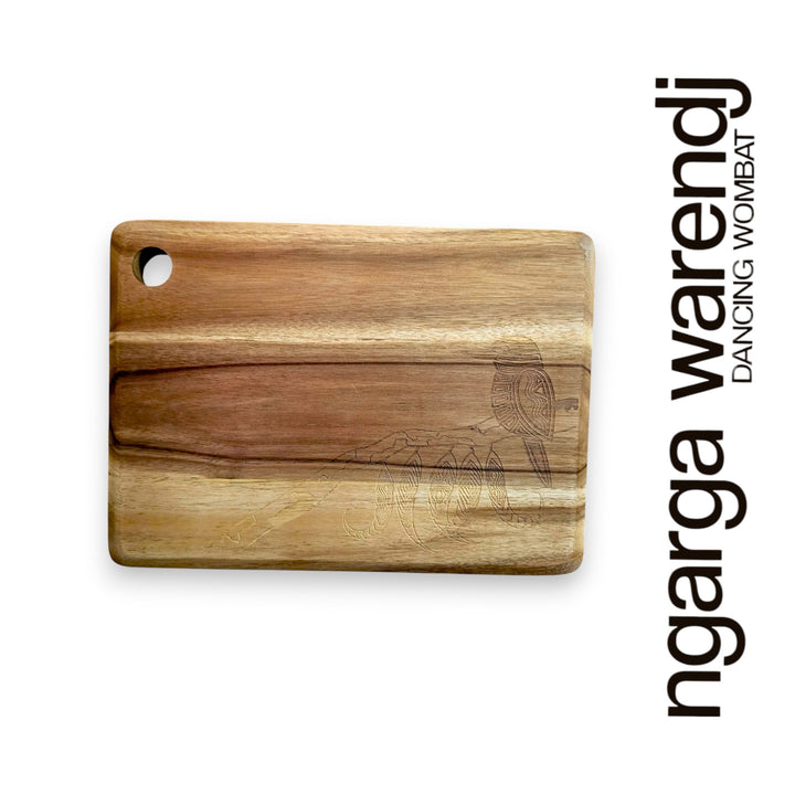 Wooden cutting board with engraved design on a white background, featuring the brand 'ngarga wardenj'.