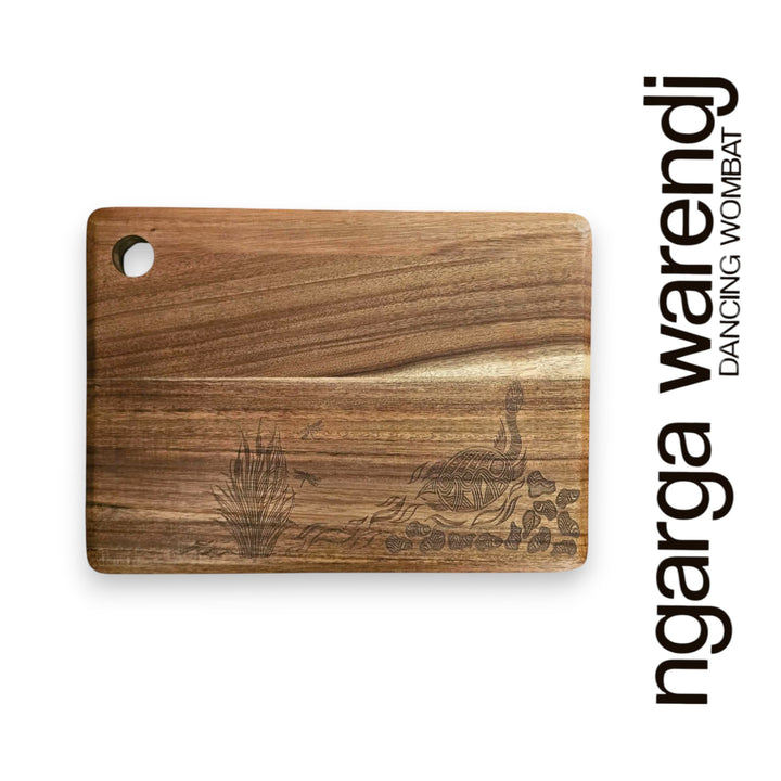 Wooden cutting board with engraved design on a white background, featuring the brand 'ngarga wardenj'.