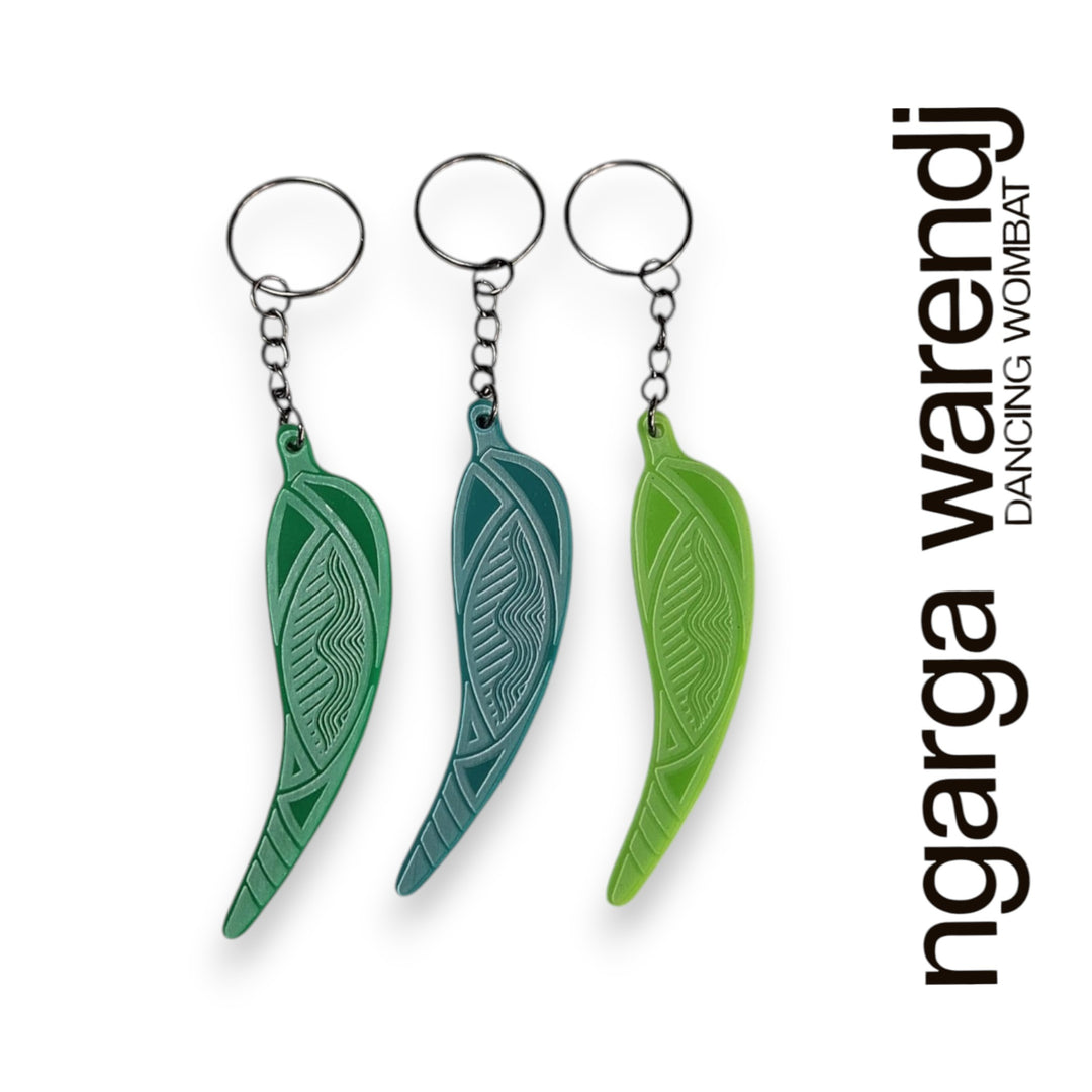 Three green leaf-shaped keychains on a white background with 'ngarga warendj' branding.