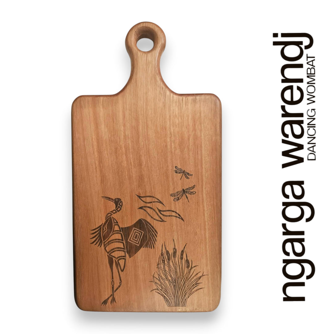 Wooden cutting board with engraved design on a white background, featuring the brand 'ngarga warendj'.