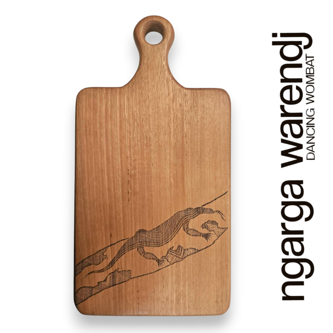 Wooden cutting board with laser engraving of a goanna, branded 'ngarga warendj'.