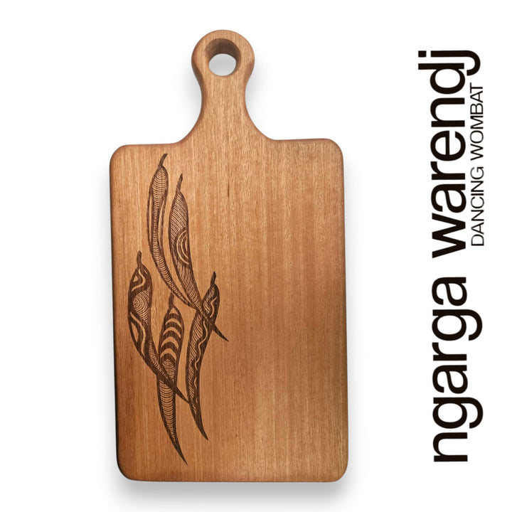 Wooden cutting board with engraved design on a white background, featuring the brand 'ngarga warendj'.