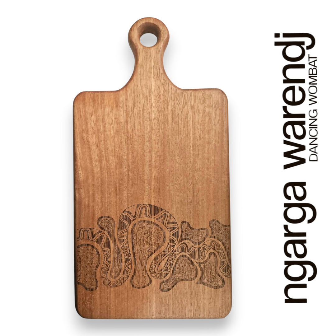 Wooden cutting board with a laser-cut design on a white background, featuring the brand 'ngarga warendj'.