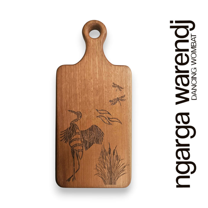 Wooden cutting board with engraved design on a white background, featuring the brand 'ngarga warendj'.