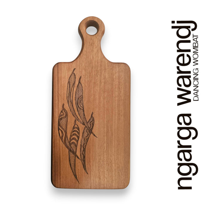 Wooden cutting board with engraved design on a white background, featuring the brand 'ngarga warendj'.