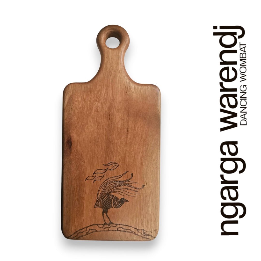 Wooden cutting board with engraved design on a white background, featuring the brand 'ngarga warendj'.