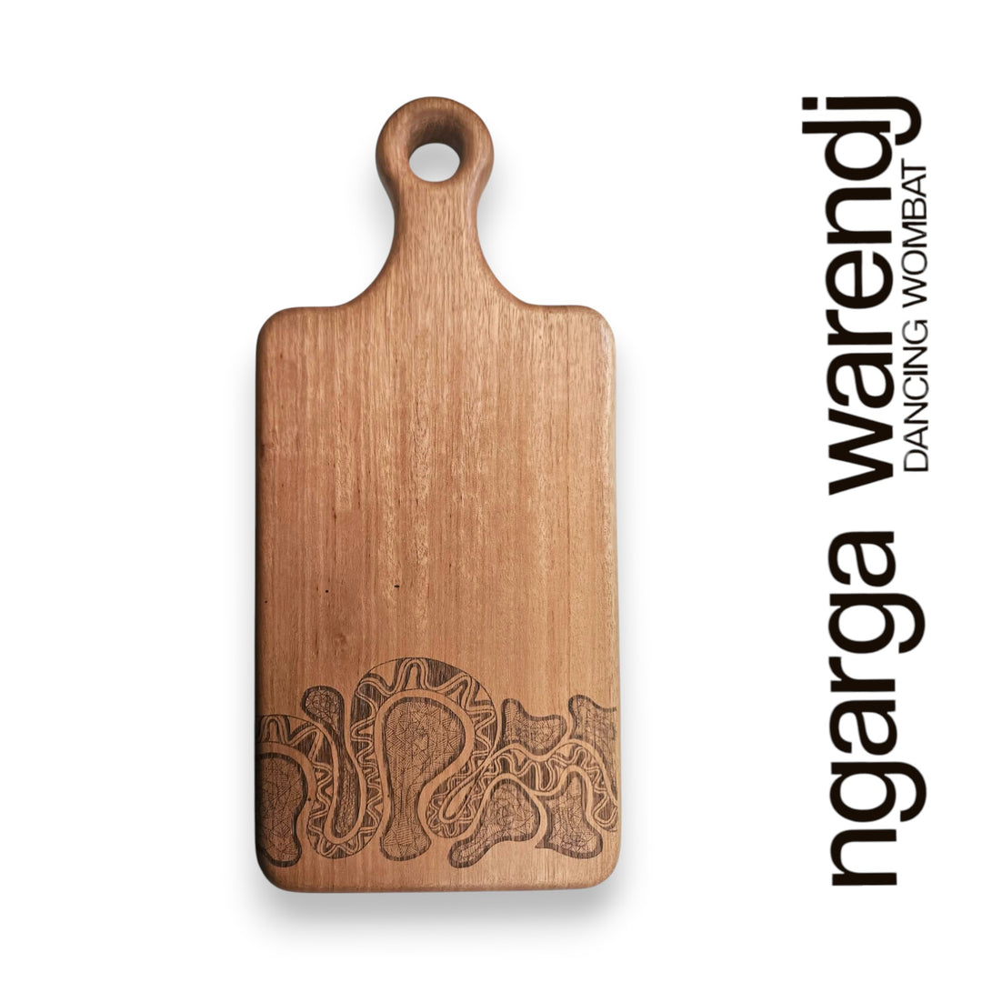 Wooden cutting board with embossed design on a white background, featuring the brand 'ngarga warendj'.