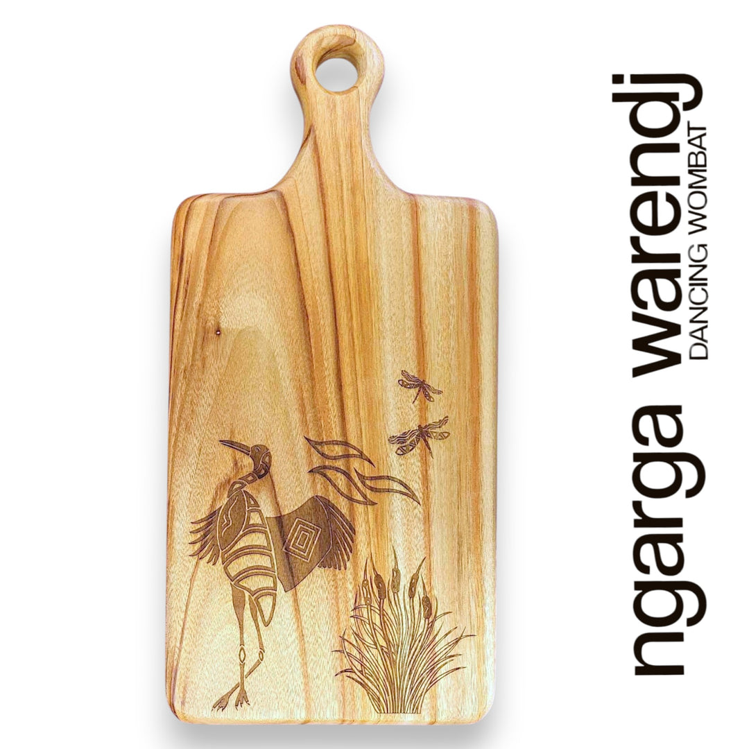 Wooden cutting board with engraved design on a white background, featuring the brand 'ngarga warendj'.