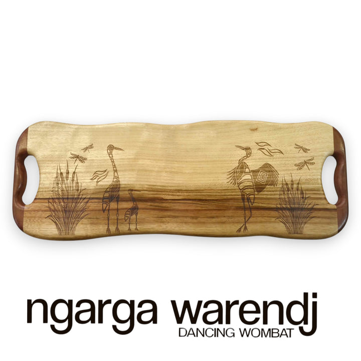 Wooden cutting board with engraved designs on a white background, featuring the brand 'ngarga warendj'.