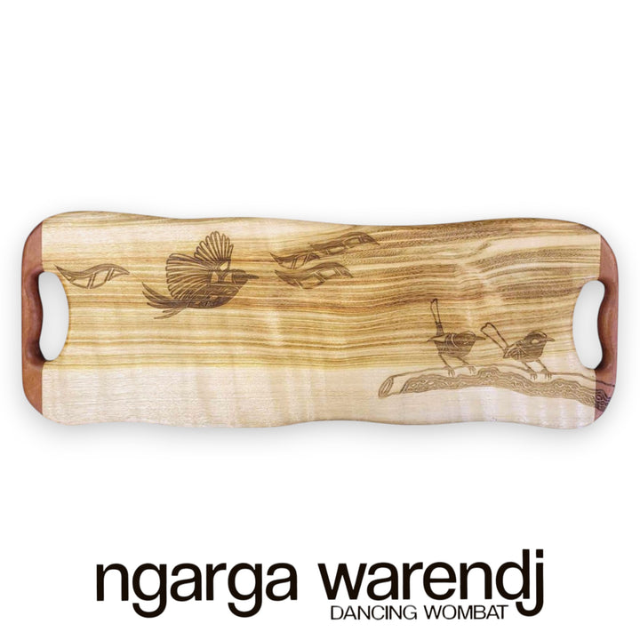 Wooden cutting board with engraved designs on a white background, featuring the brand 'ngarga warendj'.