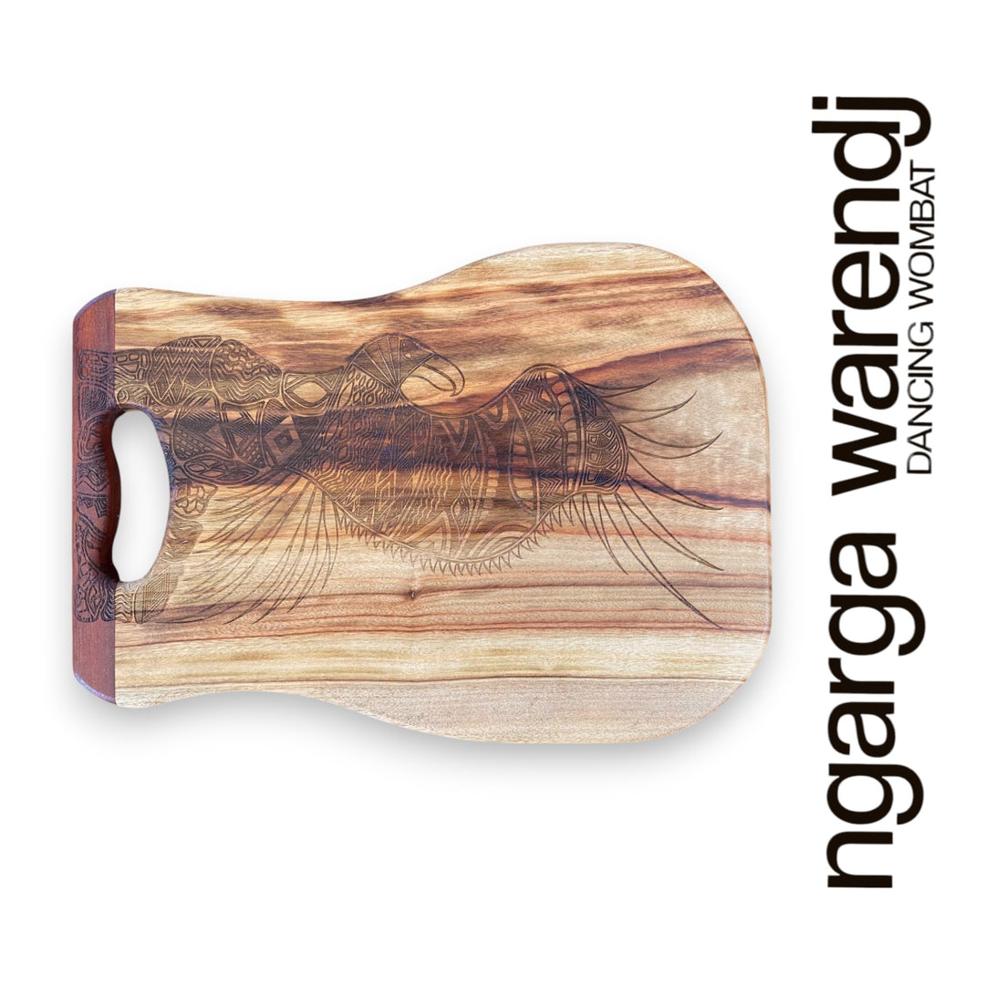 Wooden cutting board with abstract design on a white background, featuring the brand 'ngarga warendj'.