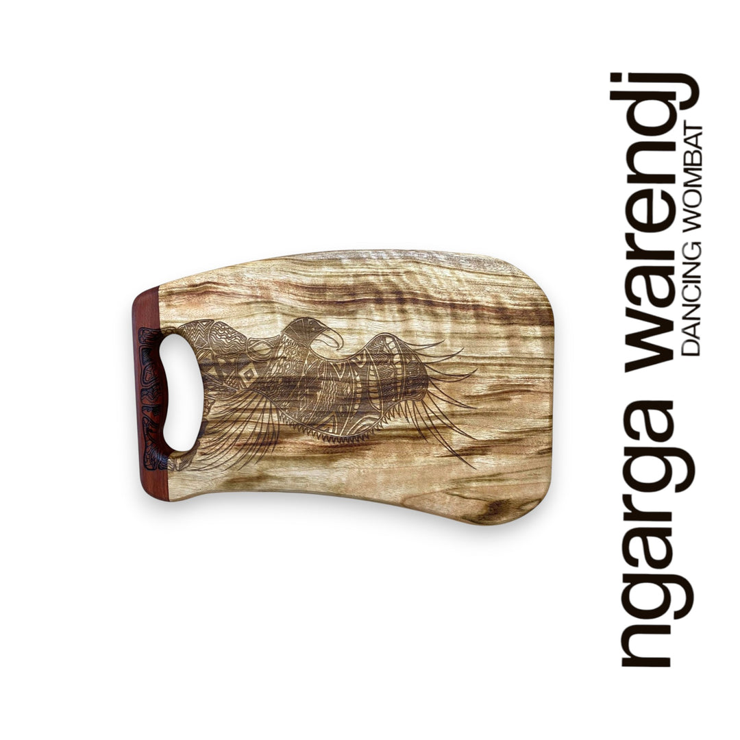 Wooden cutting board with engraved design on a white background, featuring the brand 'ngarga warendj'.