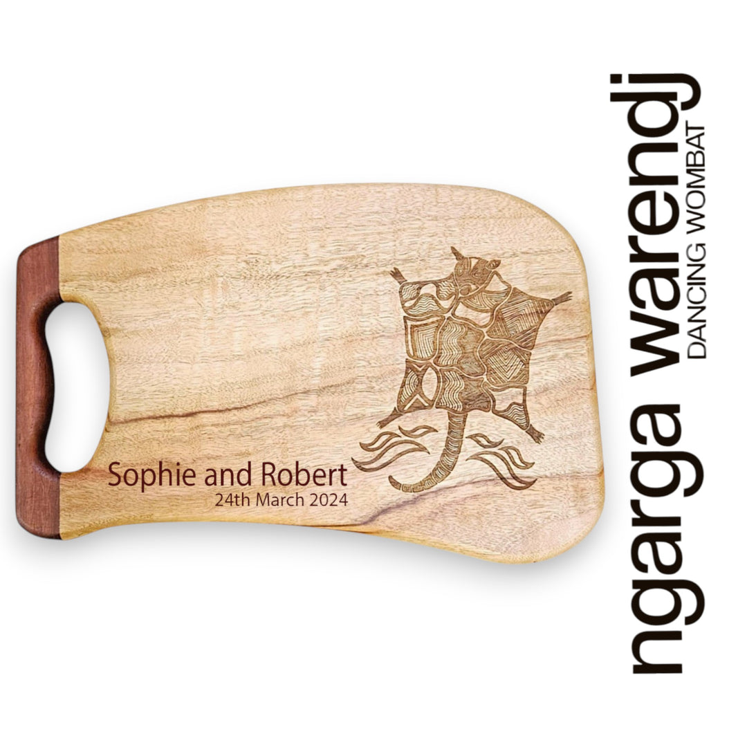 Wooden cutting board with laser engraving of a possum design and personalized text, branded 'ngarga warendj'.