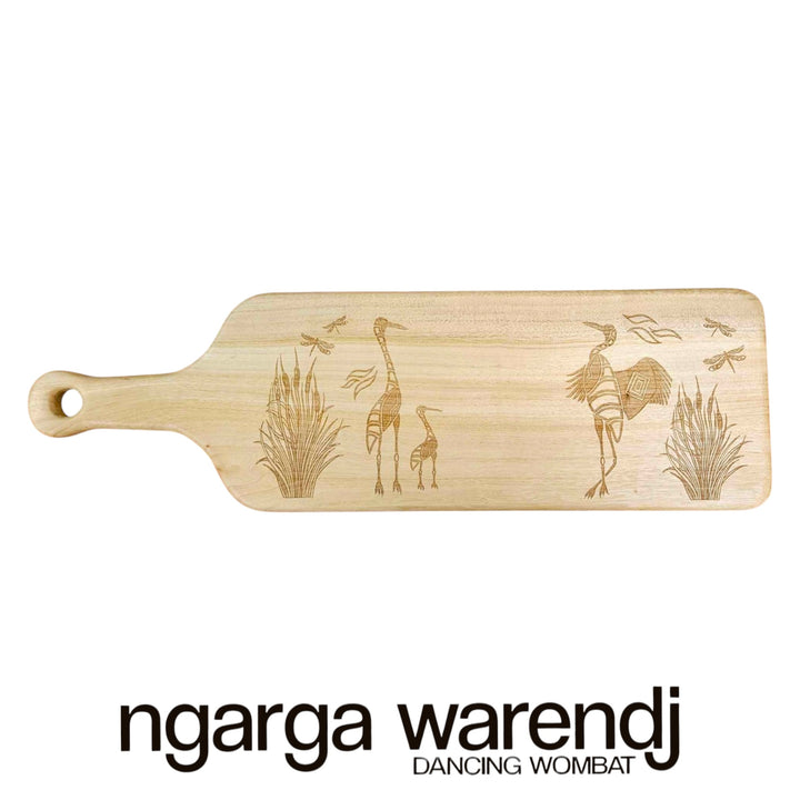 Wooden cutting board with engraved designs on a white background, featuring the brand 'ngarga warendj'.
