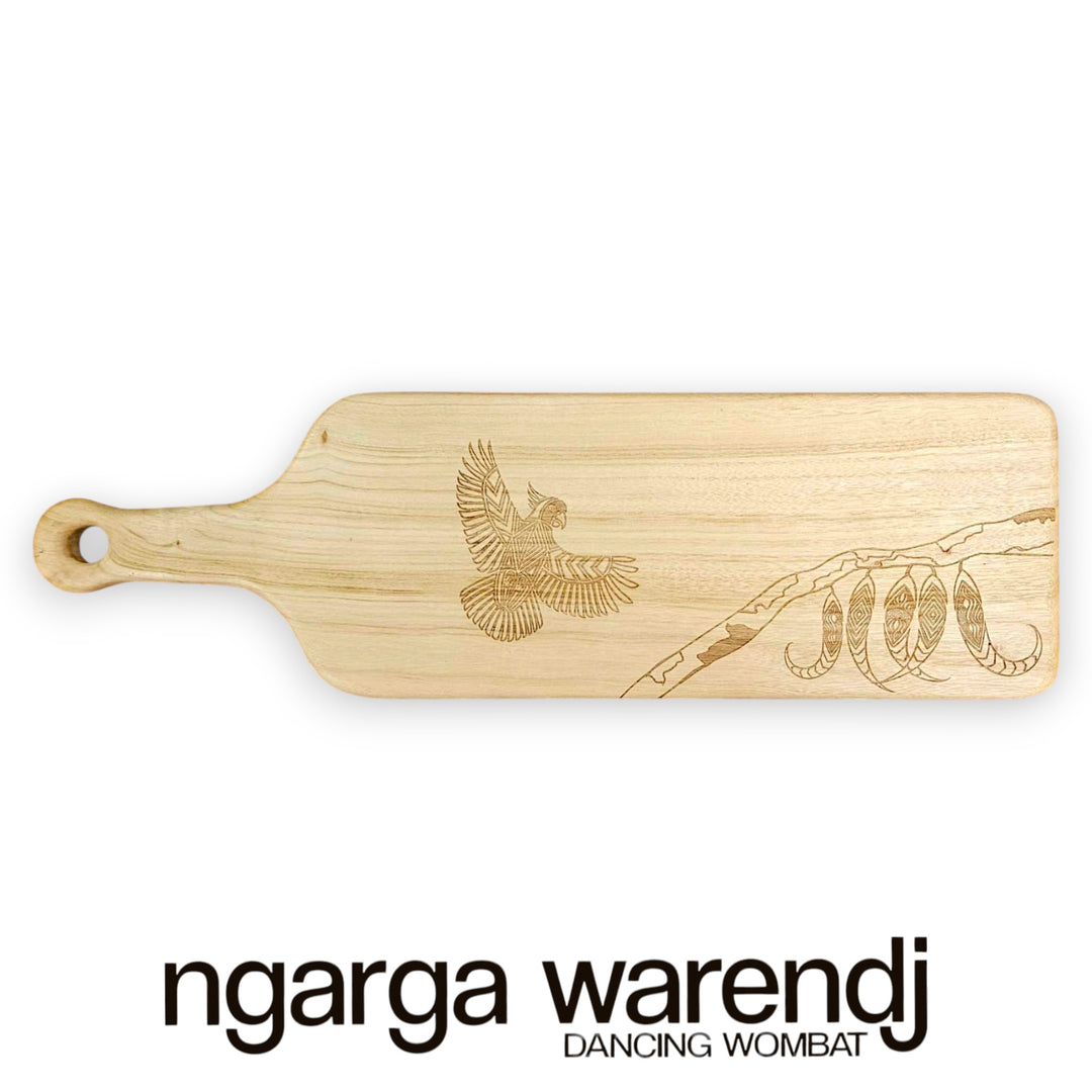 Wooden cutting board with engraved design on a white background, featuring the brand 'ngarga warendj'.