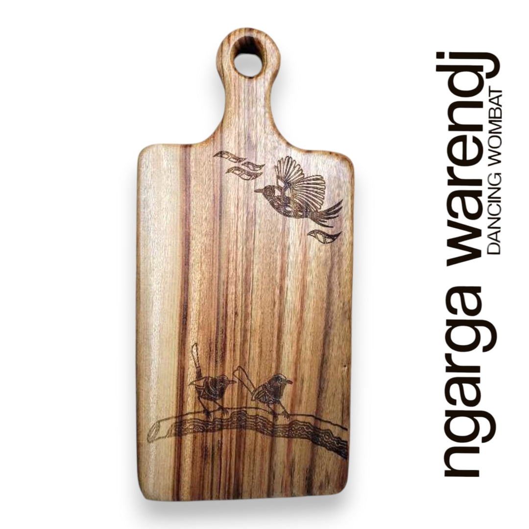 Wooden cutting board with bird designs on a white background, featuring the brand 'ngarga warendj'.