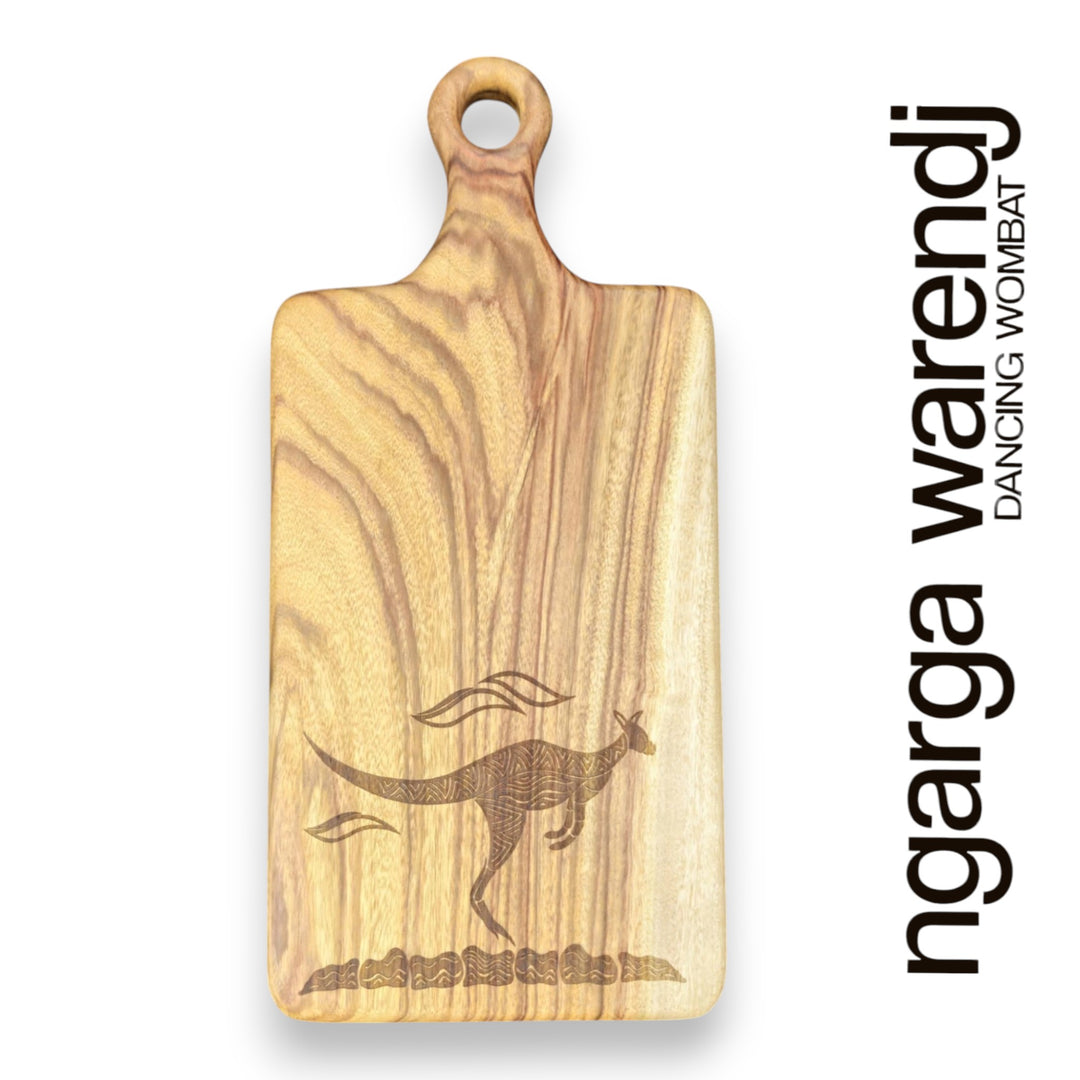Wooden cutting board with kangaroo engraving and 'ngarga warendj' branding on a white background