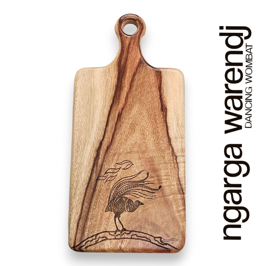 Wooden cutting board with a laser-engraved design on a white background, featuring the brand 'ngarga wardenji'.