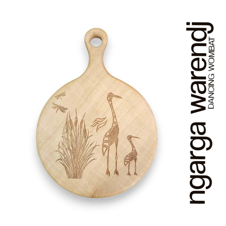 Wooden cutting board with engraved designs of a Brolga and a baby, branded 'ngarga warendj'.