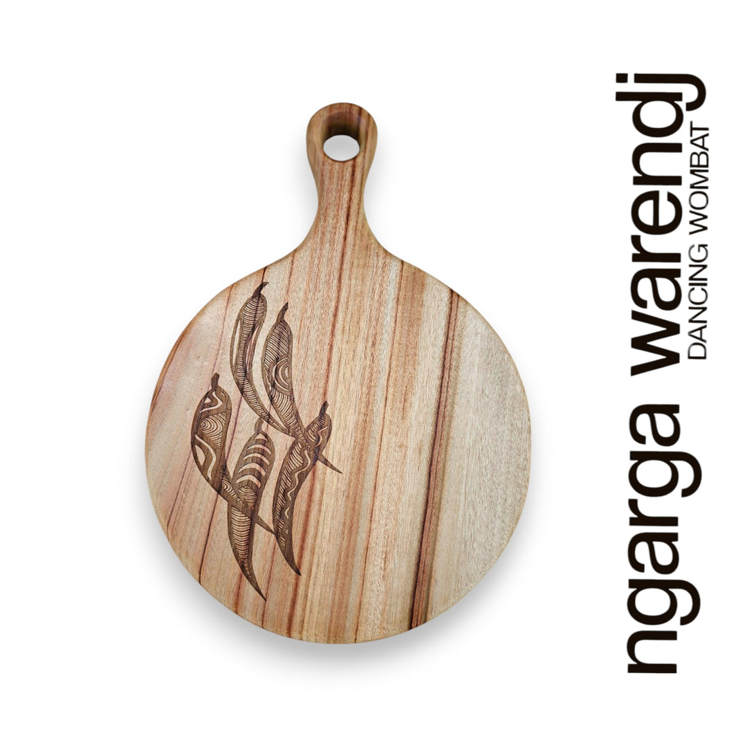 Wooden cutting board with laser-cut design on a white background, featuring the brand 'ngarga warendj'.