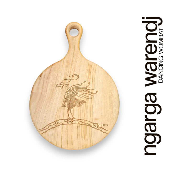 Wooden cutting board with laser engraving of a lyrebird on a white background, featuring the brand 'ngarga warendj'.