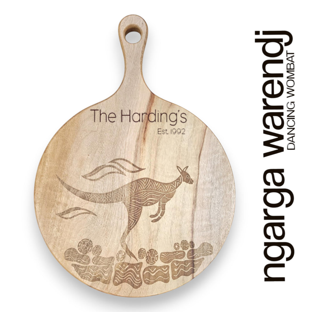 Wooden cutting board with kangaroo engraving and 'The Hardings' and Ngarga Warendj branding on a white background.