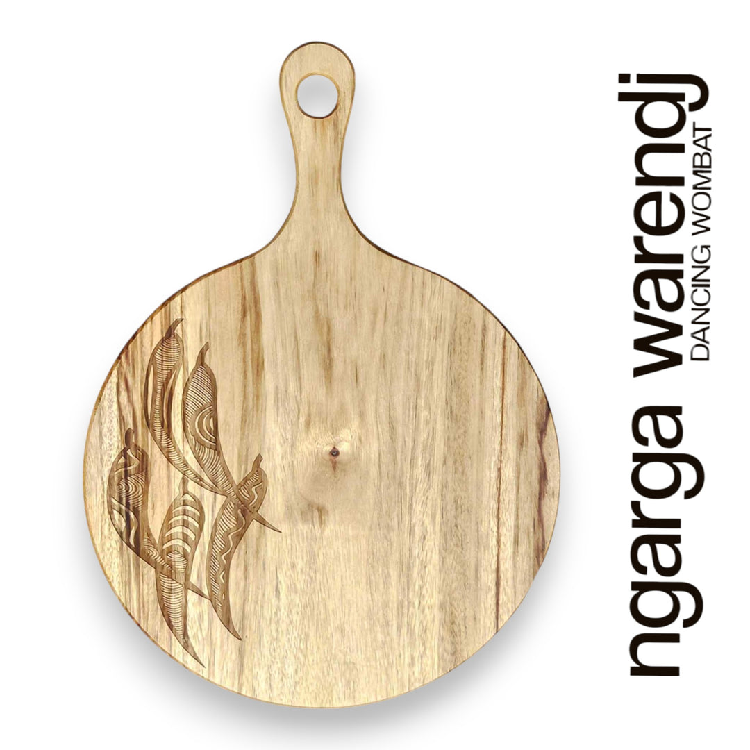 Wooden cutting board with engraved design on a white background, featuring the brand 'ngarga warendj'.