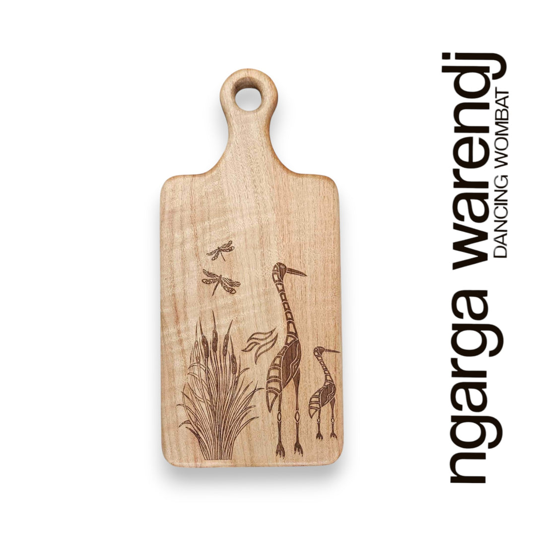 Wooden cutting board with engraved designs on a white background, featuring the brand 'ngarga warendj'.