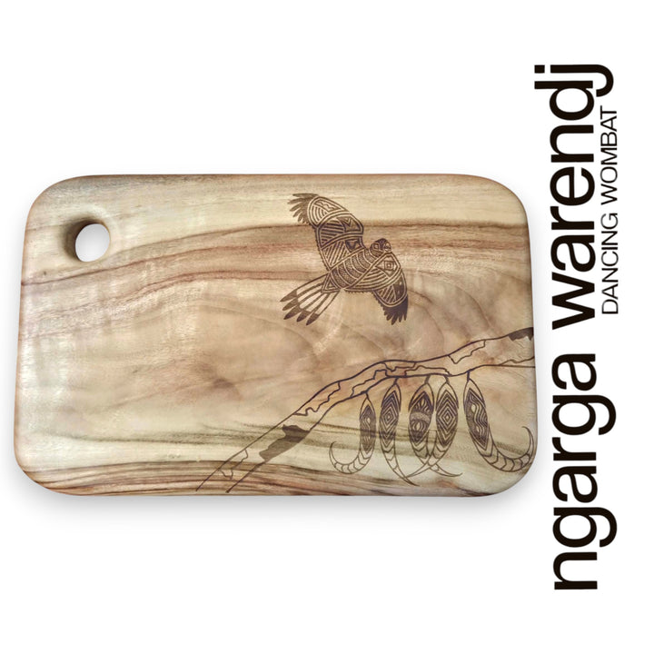 Wooden cutting board with laser-engraved designs on a white background, featuring the brand 'ngarga warendj'.