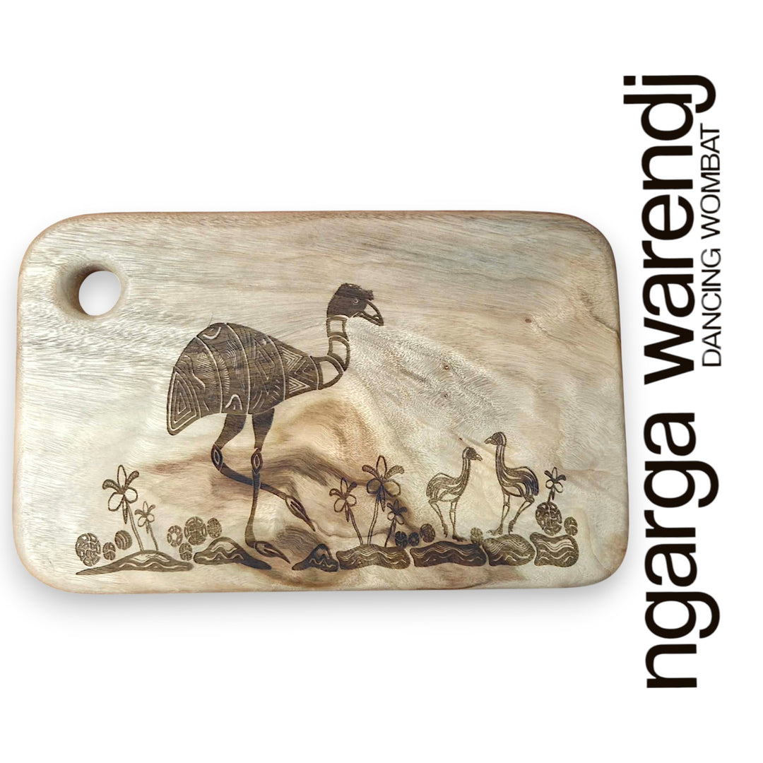 Wooden cutting board with laser-engraved designs on a white background, featuring the brand 'ngarga warendj'.