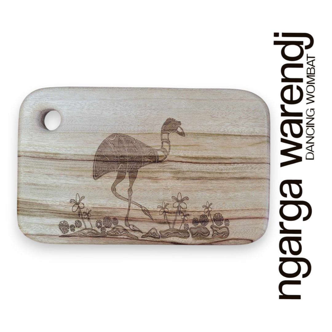 Wooden cutting board with a laser-engraved design of a dancing wombat, branded 'ngarga warendj'.