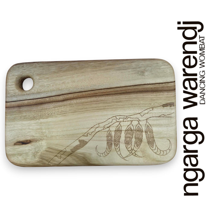 Wooden cutting board with laser-engraved designs on a white background, featuring the brand 'ngarga warendj'.