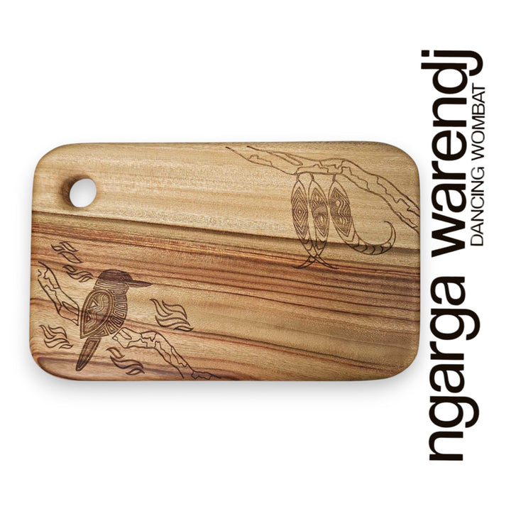 Wooden cutting board with laser-engraved designs on a white background, featuring the brand 'ngarga warendj'.