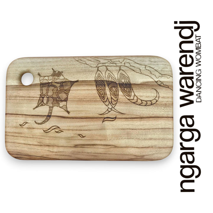 Wooden cutting board with laser-engraved designs on a white background, featuring the brand 'ngarga warendj'.