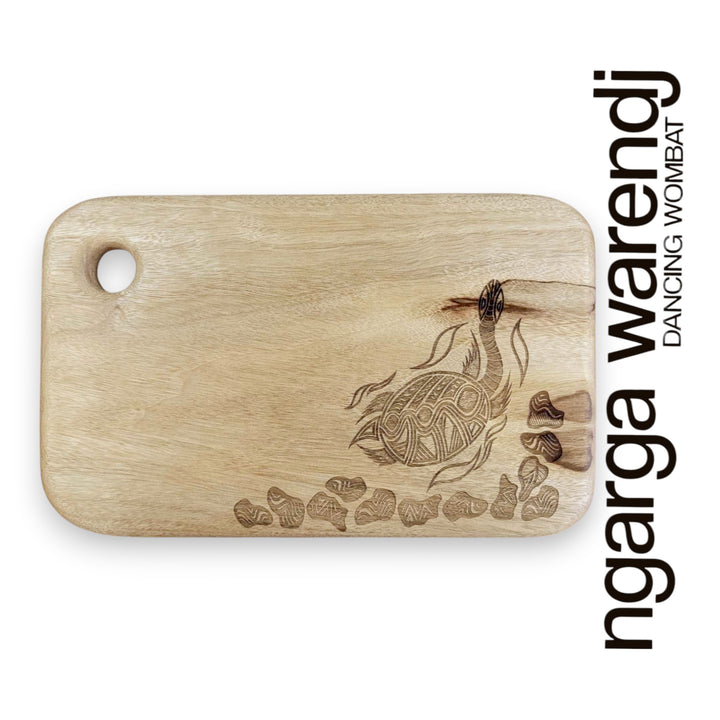Wooden cutting board with a turtle design and 'ngarga warendj' branding on a white background