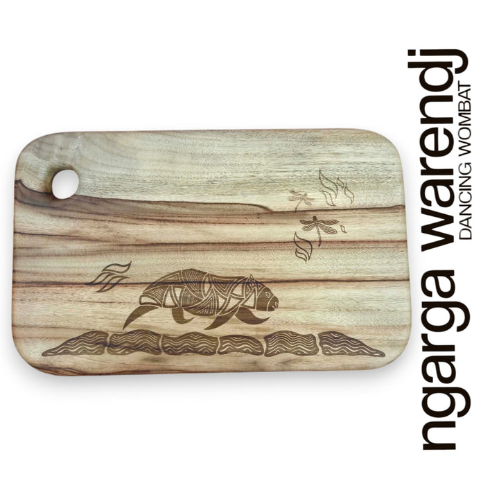 Wooden cutting board with laser-engraved designs on a white background, featuring the brand 'ngarga warendj'.