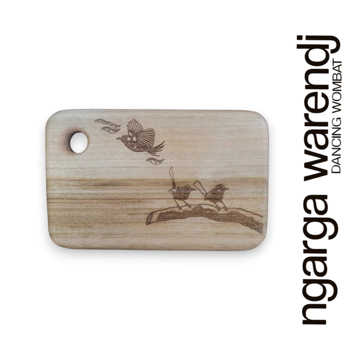 Wooden cutting board with laser-engraved design on a white background, featuring the brand 'ngarga warendj'.