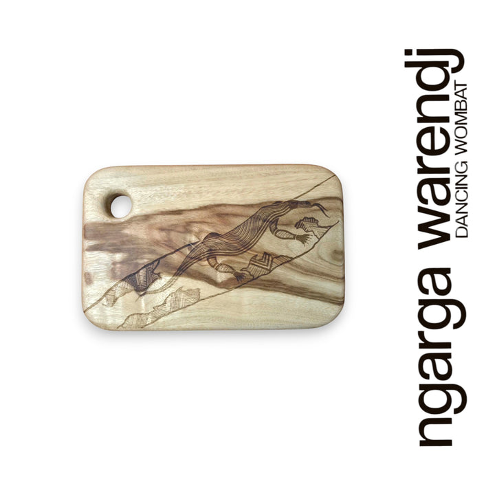 Wooden cutting board with laser engraving of a goanna design on a white background, featuring the brand 'ngarga warendj'.