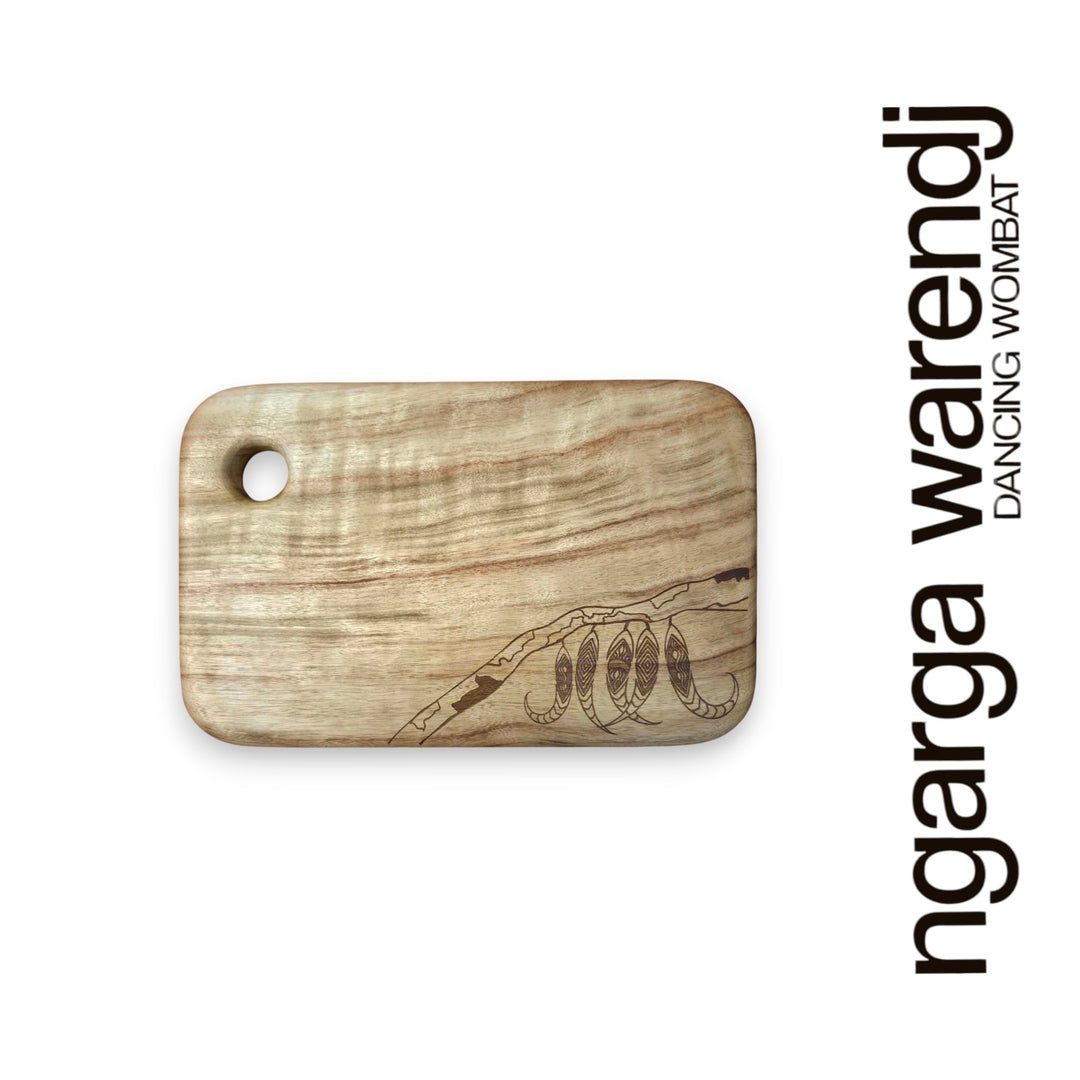 Wooden cutting board with laser engraving on a white background, featuring the brand 'ngarga warendj'.