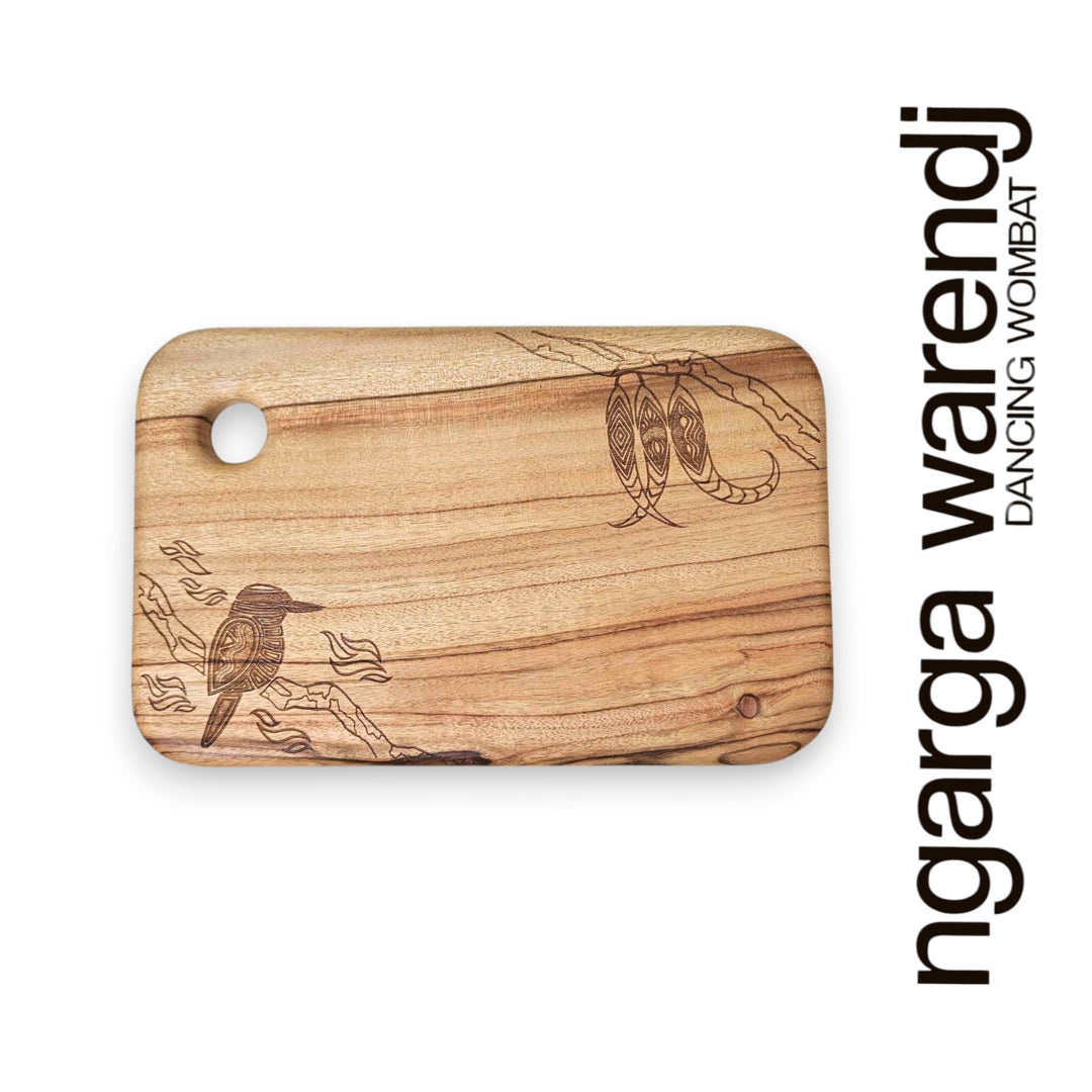 Wooden cutting board with laser-engraved designs on a white background, featuring the brand 'ngarga warendj.